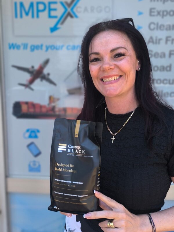 Charlene from Impex Cargo with a bag of Concept Black Signature Blend