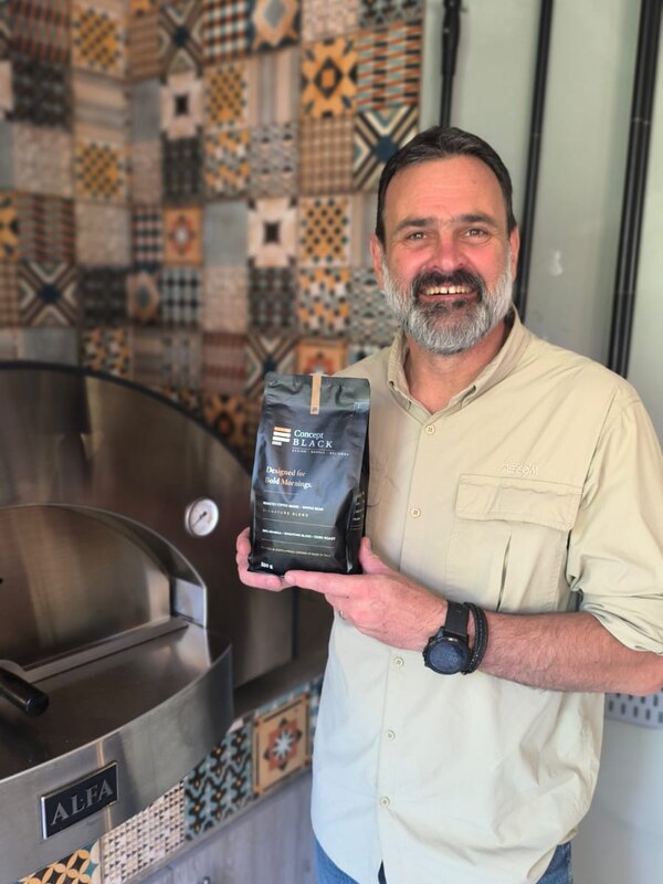 Jacques from AECOM with a bag of Concept Black Signature Blend